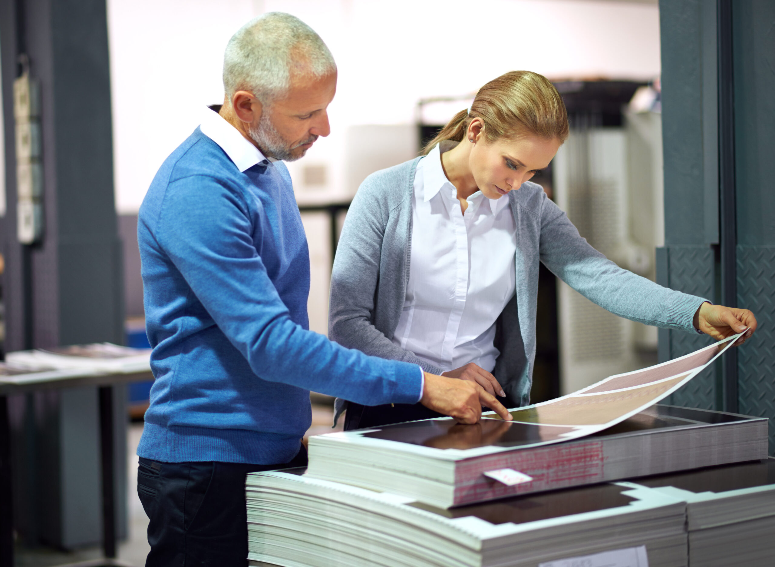 This is good work...Two publishers assessing the quality of printed work in a factory